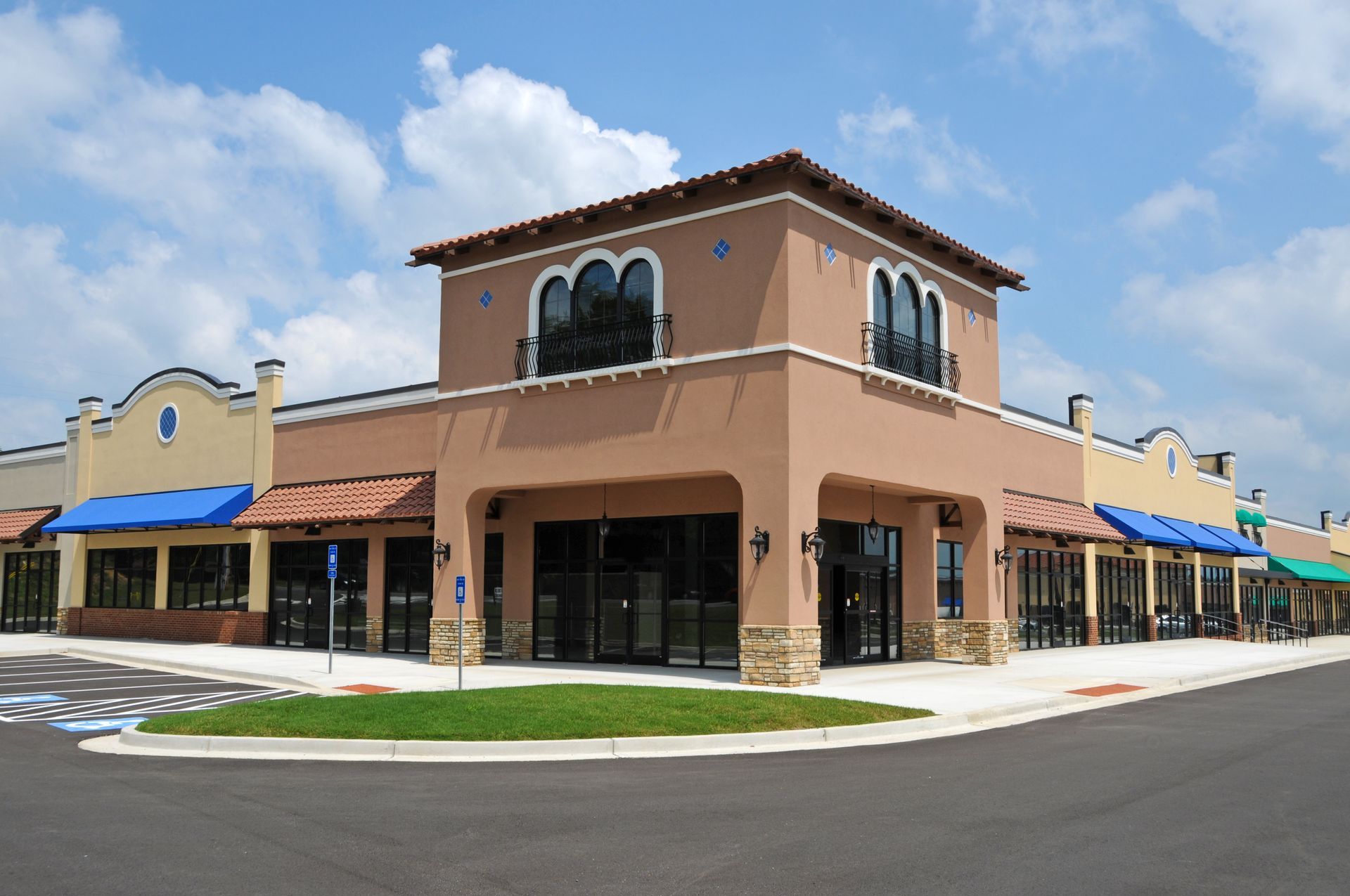 Exterior of a cafe with large windows, an open door, and a black awning. Exterior of a cafe with large windows, an open door, and a black awning.