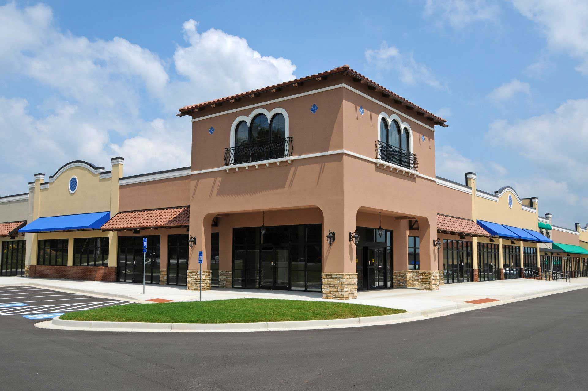 Exterior of a cafe with large windows, an open door, and a black awning.