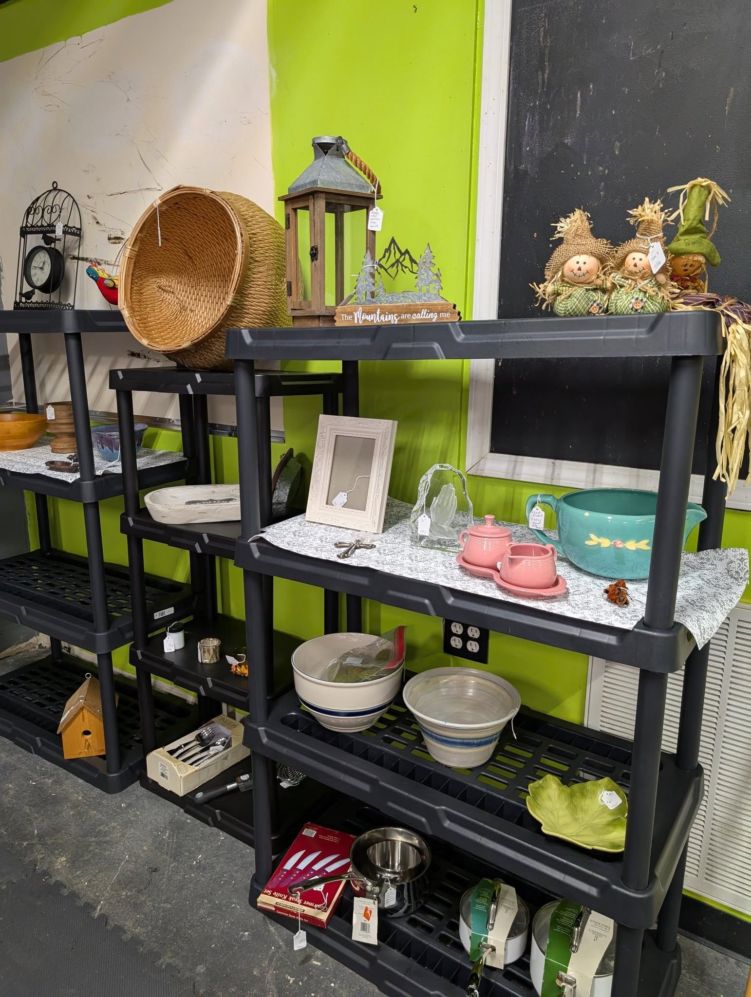 Shelves displaying various thrift store items including baskets, bowls, and decorative objects.