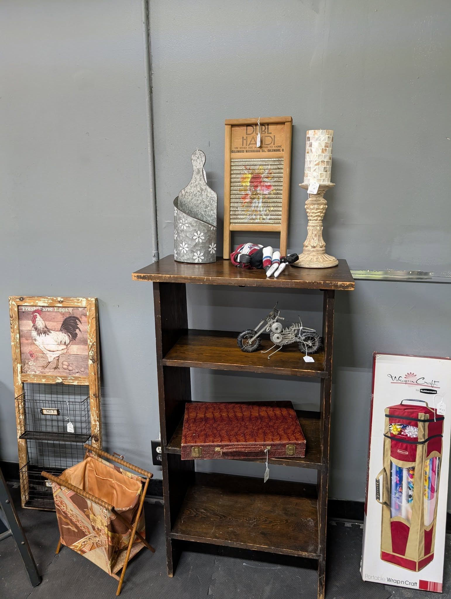 Display of antique items, including a shelf, artwork, and various decorative pieces.