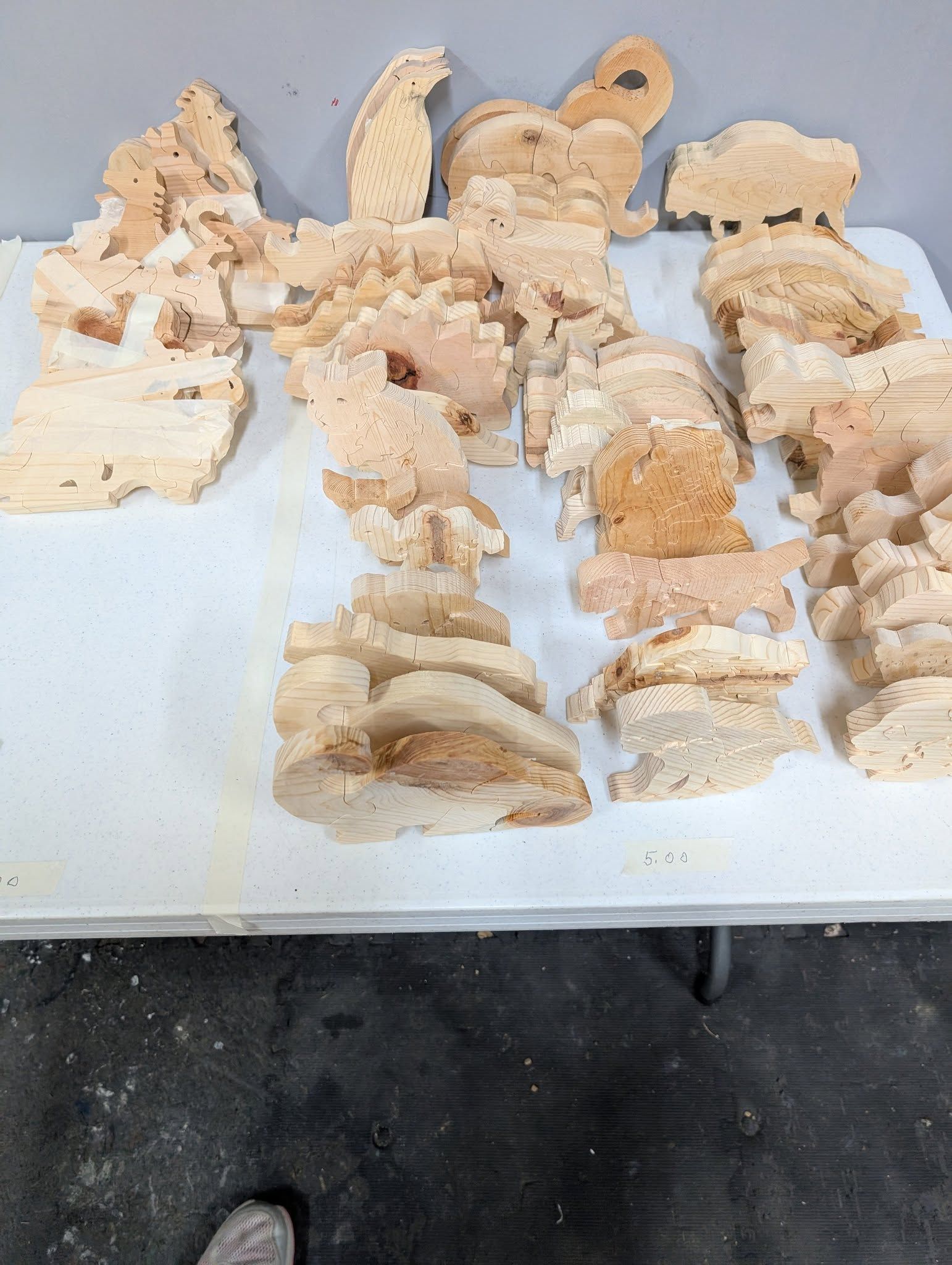 Various light-colored, porous rock formations arranged on a white surface.