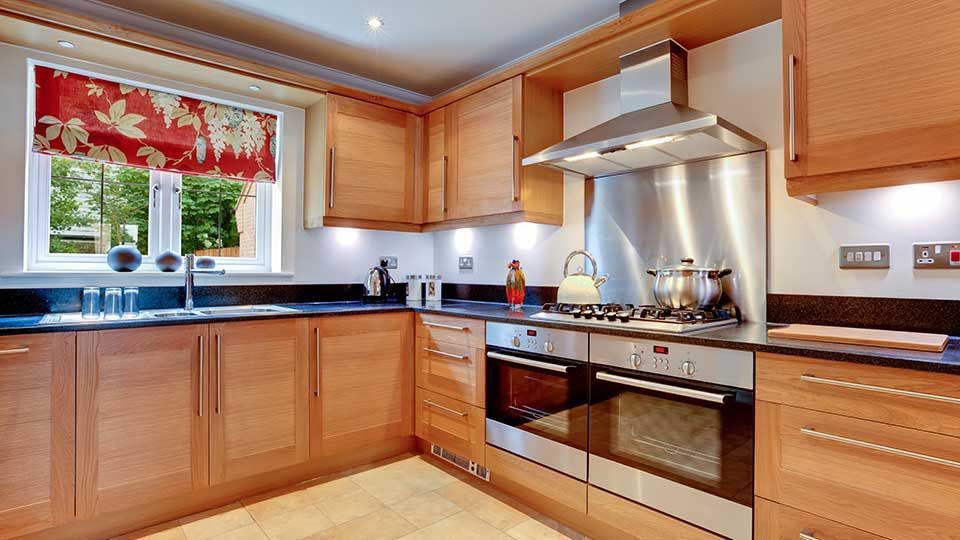 A kitchen with wooden cabinets and stainless steel appliances.