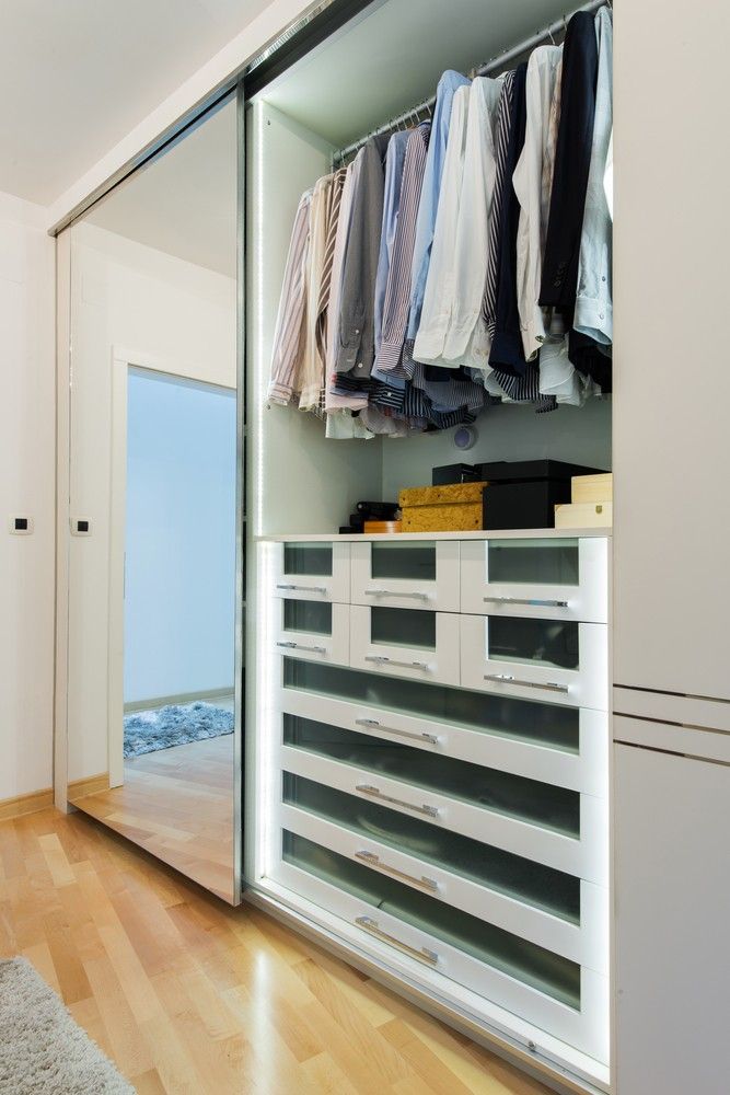A Walk in Closet With Sliding Glass Doors Filled With Clothes and Drawers — Whitsunday Screens & Grilles In Proserpine, QLD