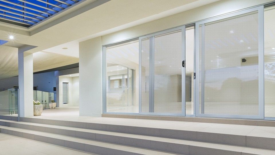 A Building With Sliding Glass Doors and Stairs Leading to It — Whitsunday Screens & Grilles In Proserpine, QLD