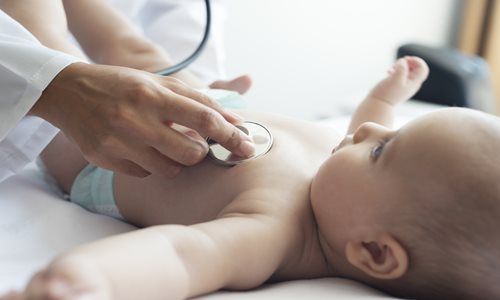 Doctor listening to baby's heart with a stethoscope
