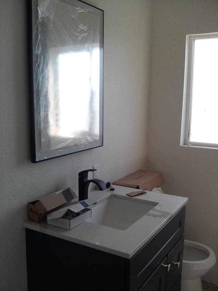 A bathroom with a bathtub , toilet , sink and mirror.