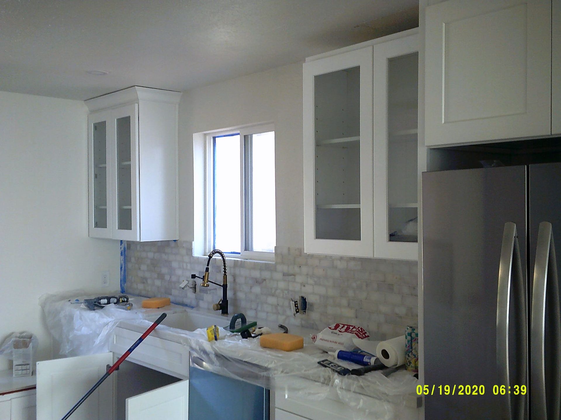 A living room with a chair and a concrete wall.