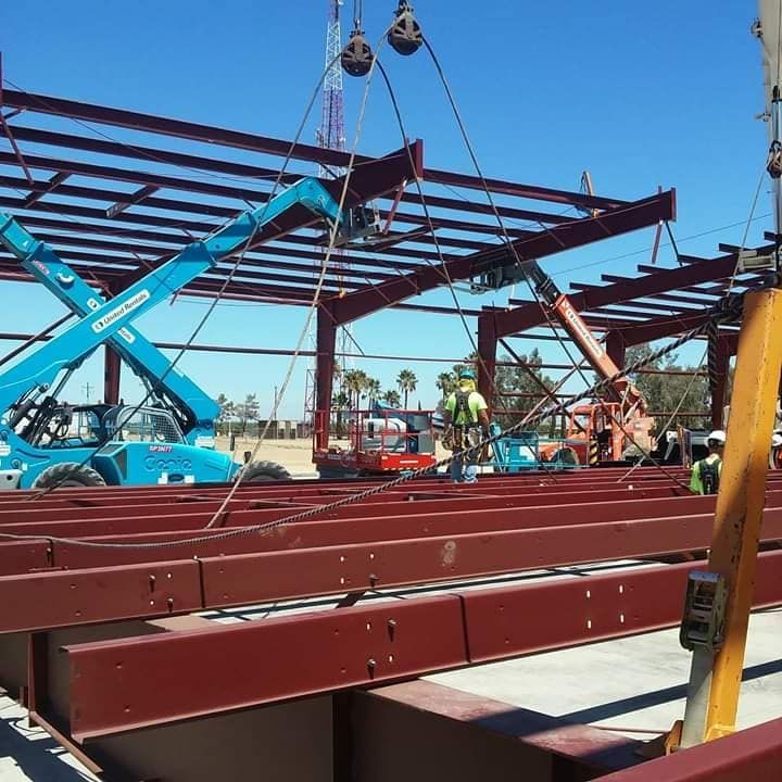 Two construction workers are working on a building under construction.