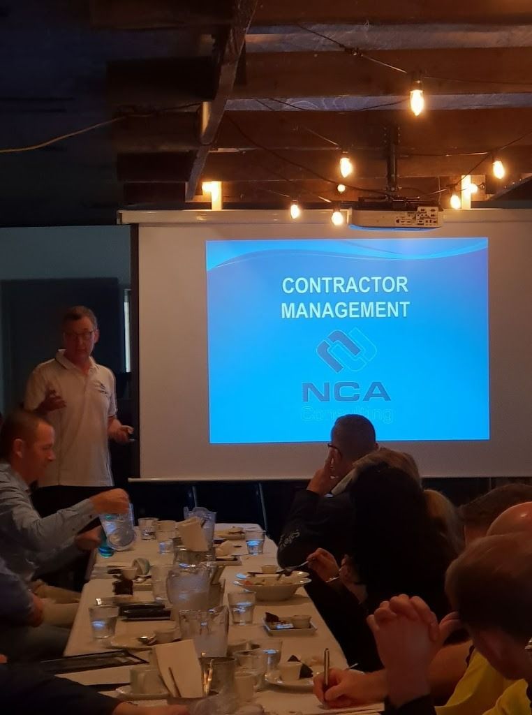 A Man Is Giving A Presentation About Contractor Management — NCA Consulting Pty Ltd in Alstonville, NSW