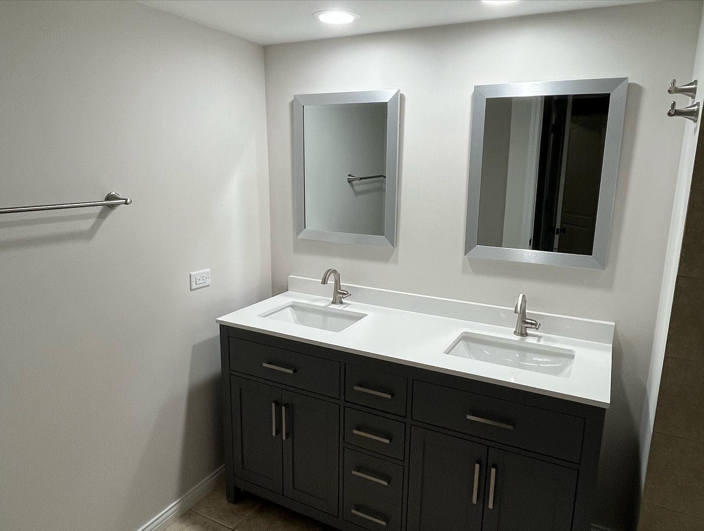A bathroom with two sinks and two mirrors