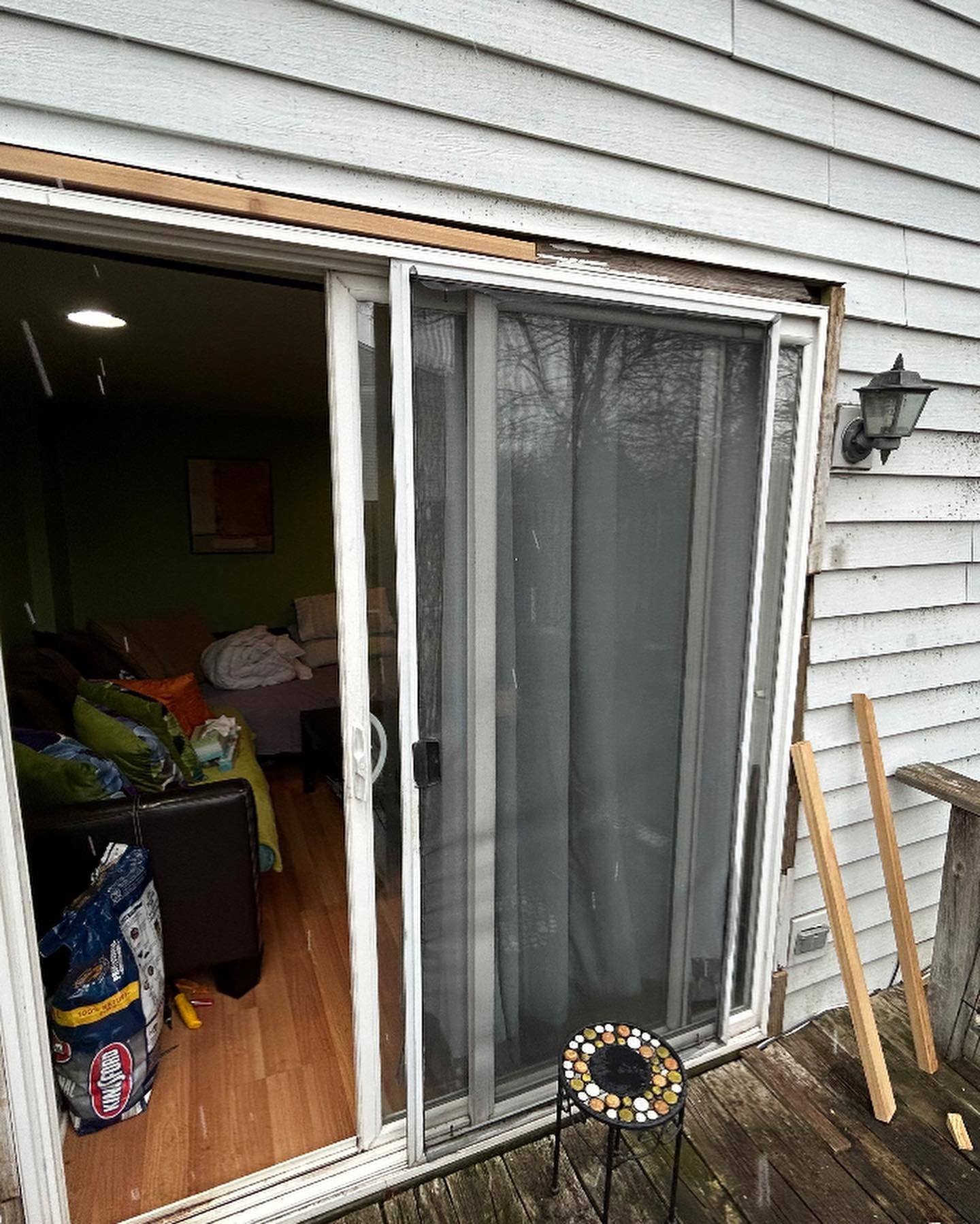 A sliding glass door is open to a living room.