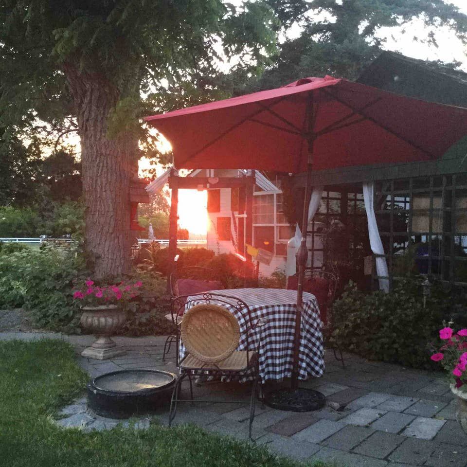 A patio with a table and chairs under an umbrella