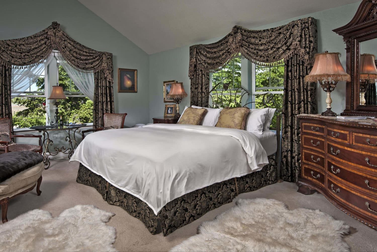 A bedroom with a king size bed and a dresser