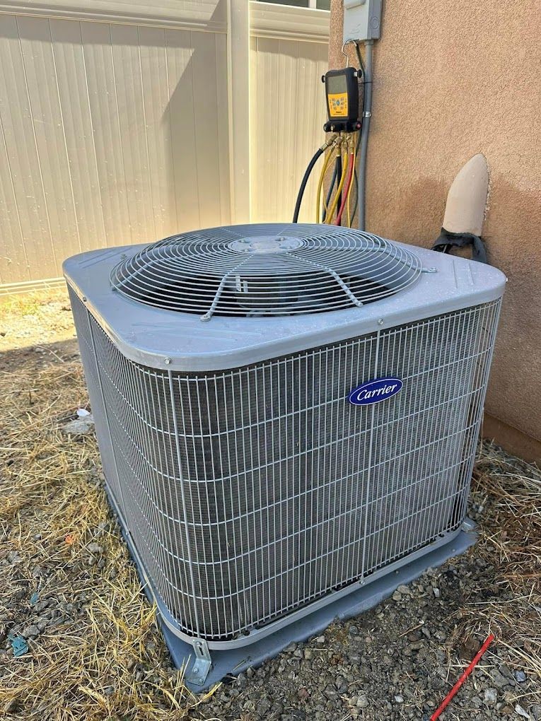 A large air conditioner is sitting outside of a house.