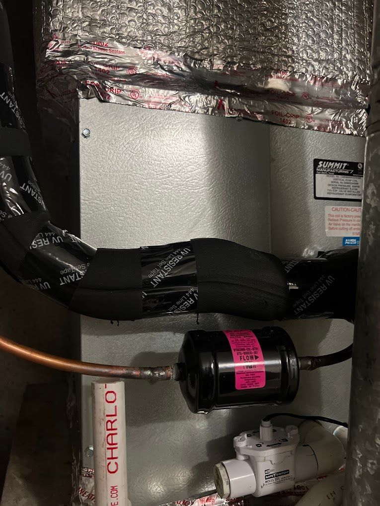 A close up of an air conditioner with a hose attached to it.