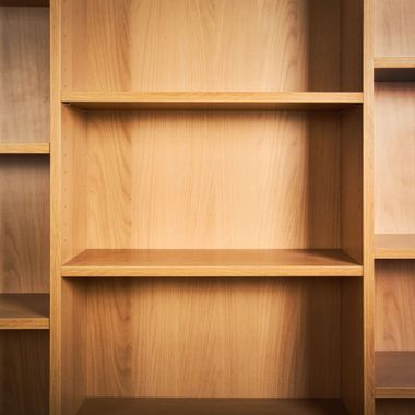 Elite Insta Bros Designs llc - Empty wooden bookshelf with three shelves.