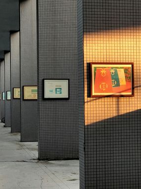 Elite Insta Bros Designs llc - Black and white photographs hanging on a stone wall, depicting various scenes.