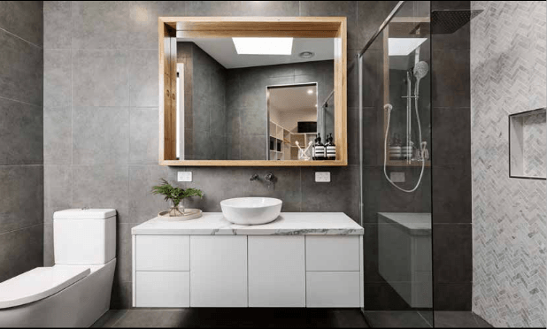 Modern Bathroom with floating wooden cabinetry and circle mirror — Bathroom Vanities in Toowoomba , QLD