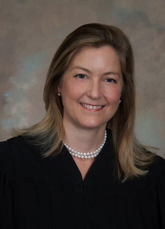 A woman in a blue shirt is smiling for the camera. - New Albany, Indiana, Timmel Law Office