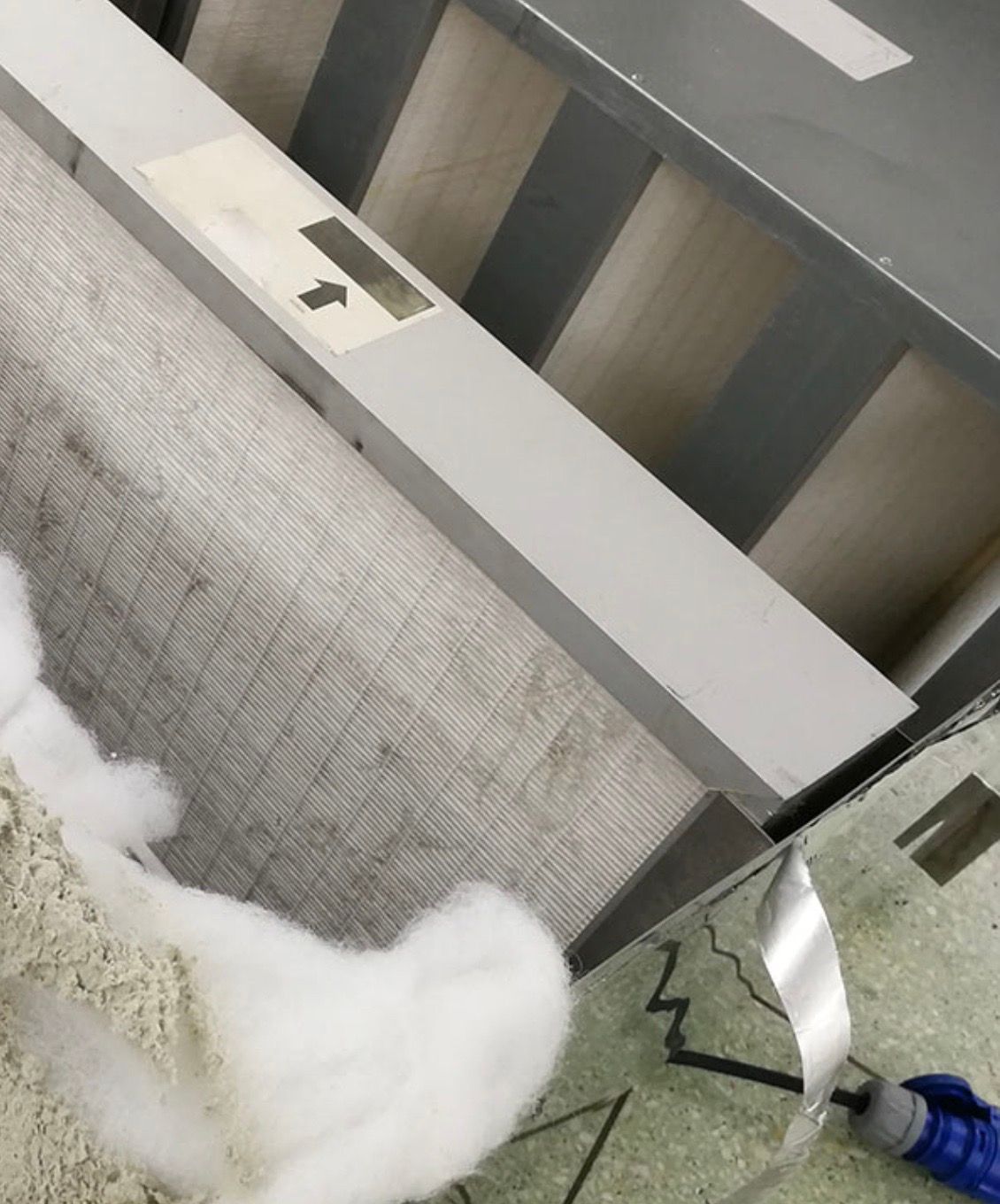 A stuffed animal is sitting on a table next to a mirror