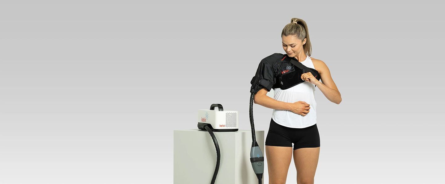 A man is laying on a stretcher in a room.