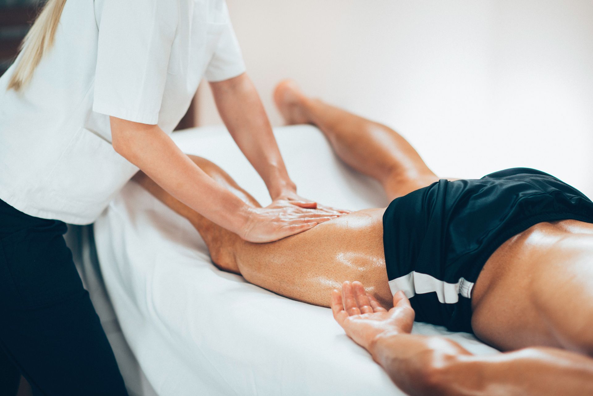A man is getting a massage from a woman in a spa.