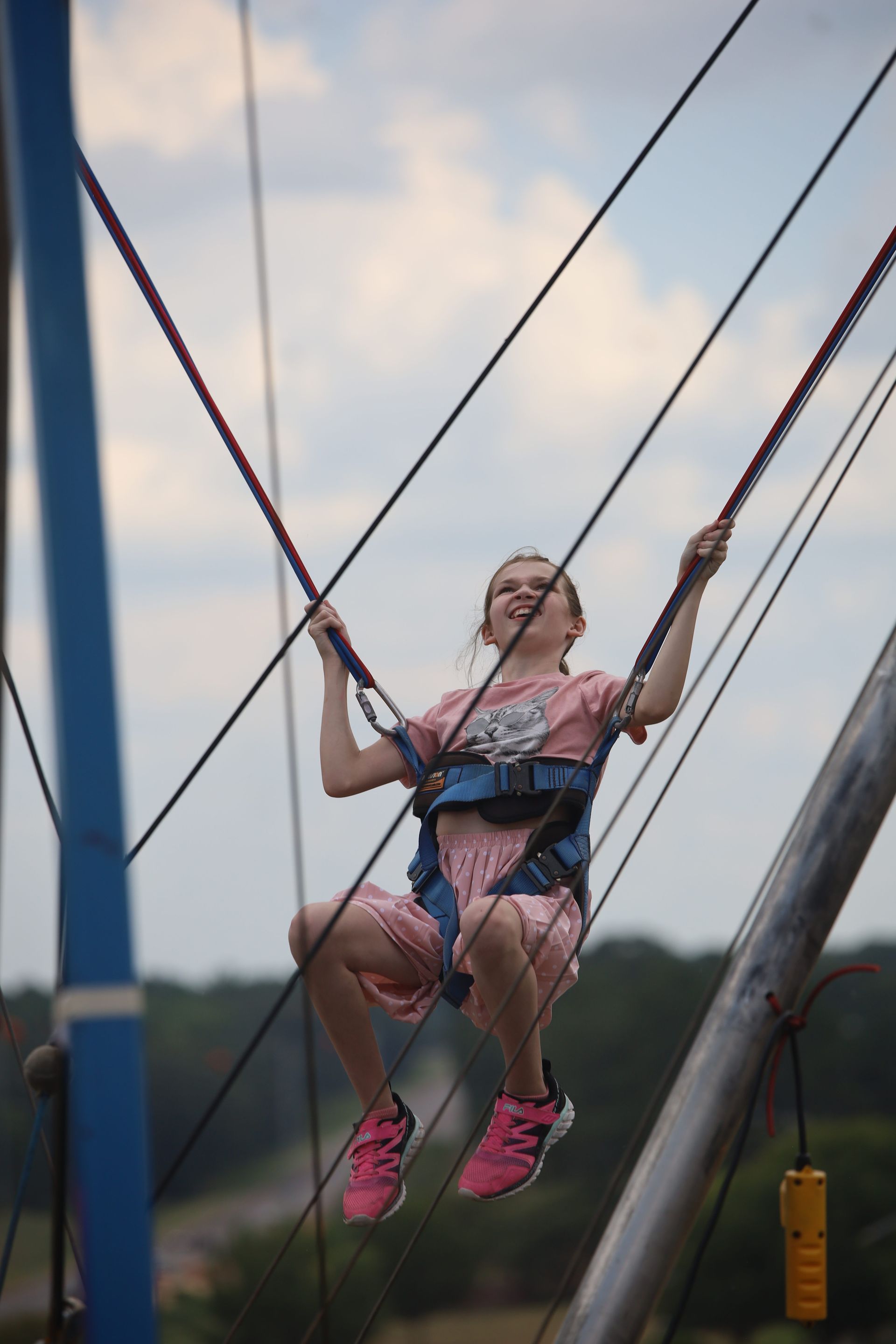 A young girl is riding a bungee trampoline.