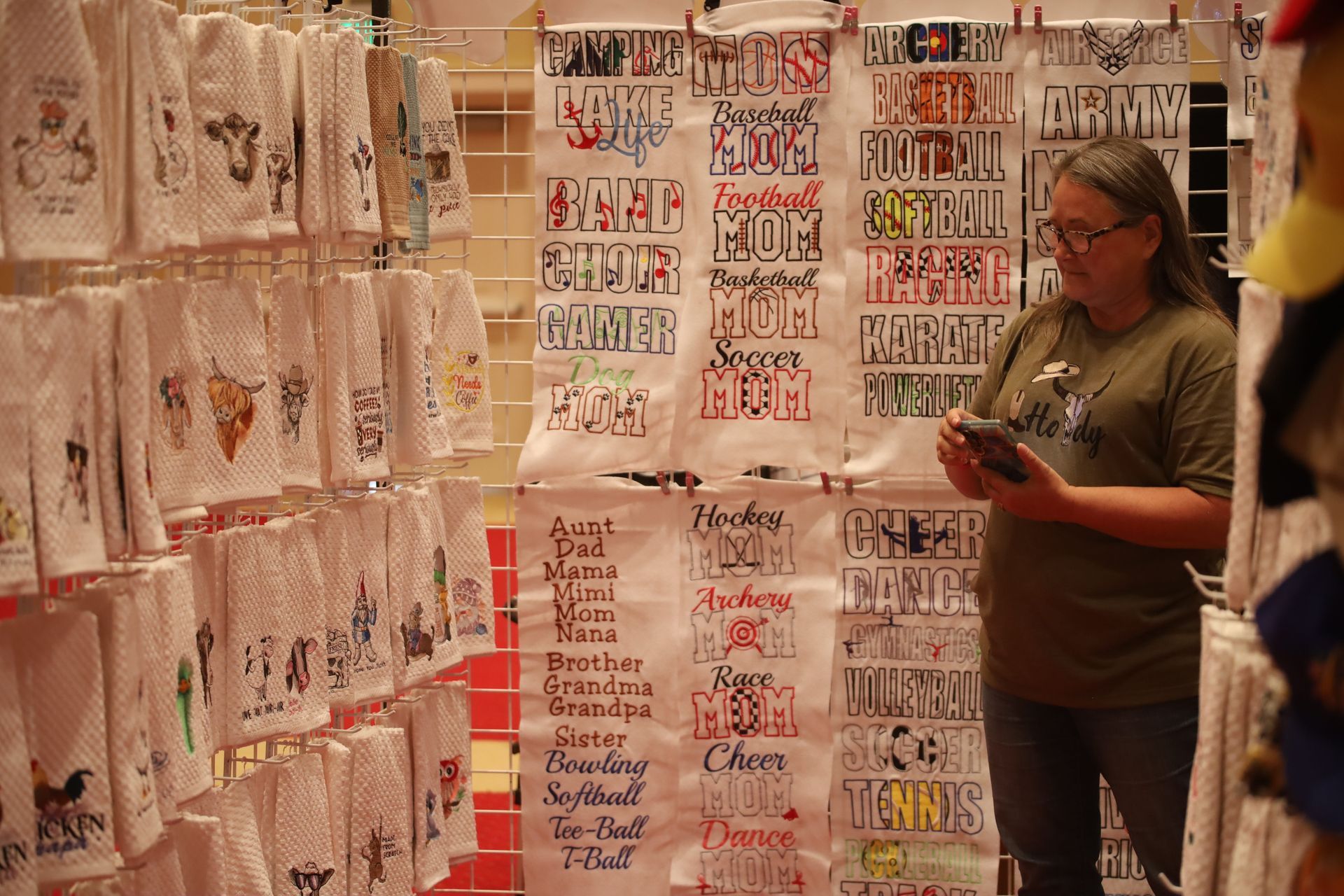 A woman is standing in front of a display of towels.