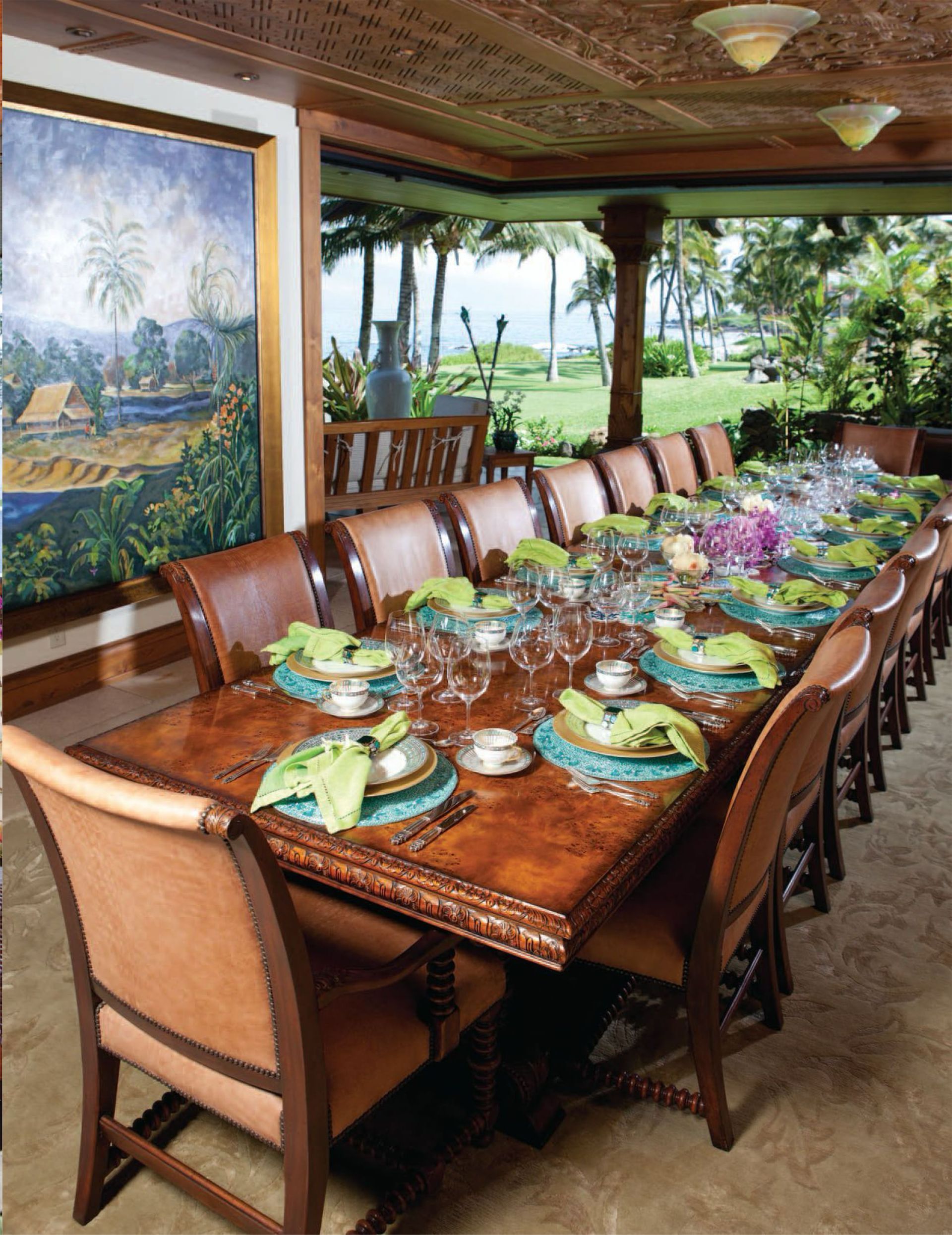 An image of the Makena Waterfront Estate long dining table with plates and glasses on it featured in Gentry Home Magazine.