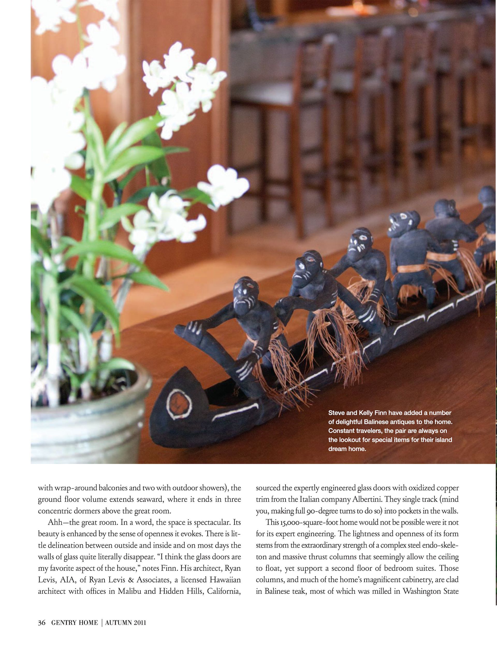 An art piece on a table next to a potted plant from the Makena Waterfront Estate in an excerpt in Gentry Home Magazine