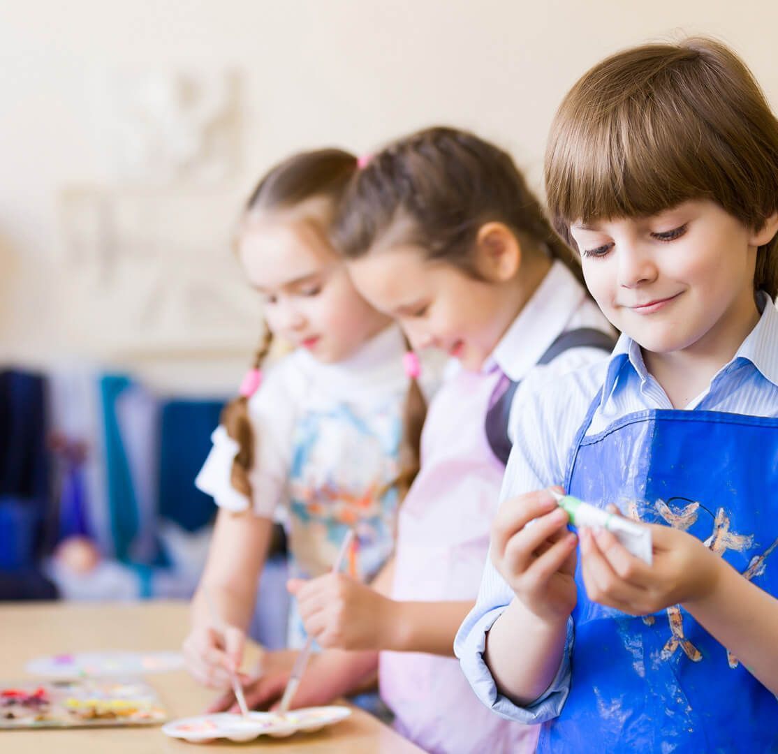 A boy wearing a blue apron with a star on it
