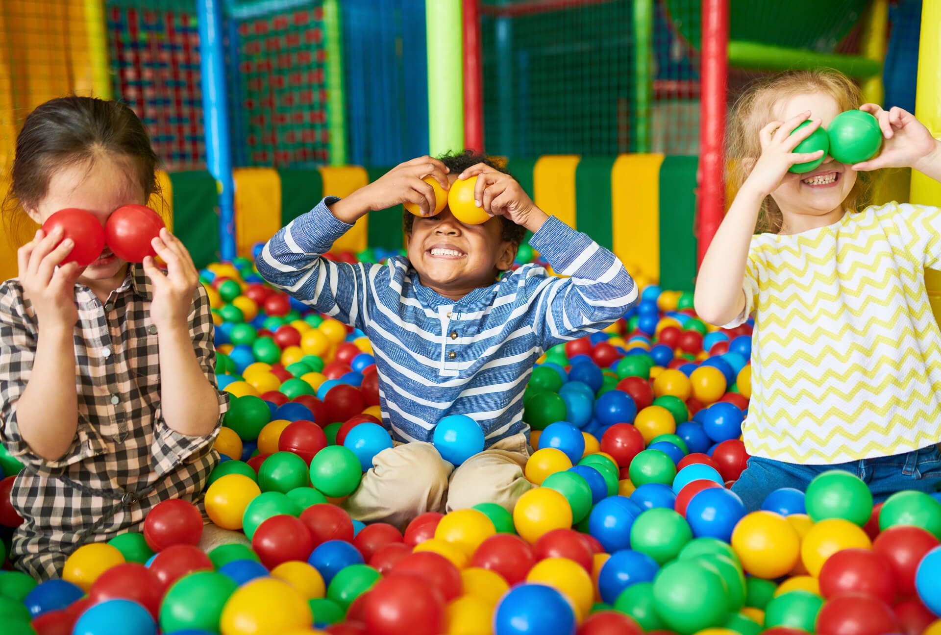 A group of children are playing in a ball pit.