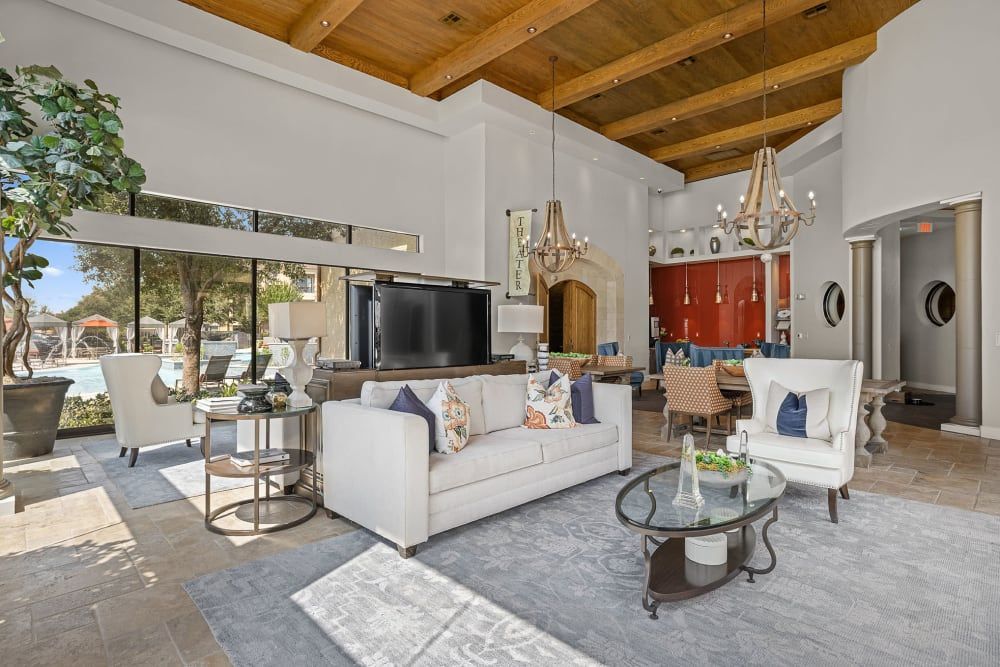 Apartment clubhouse filled with furniture and television at Marquis at the Reserve in Katy, TX.