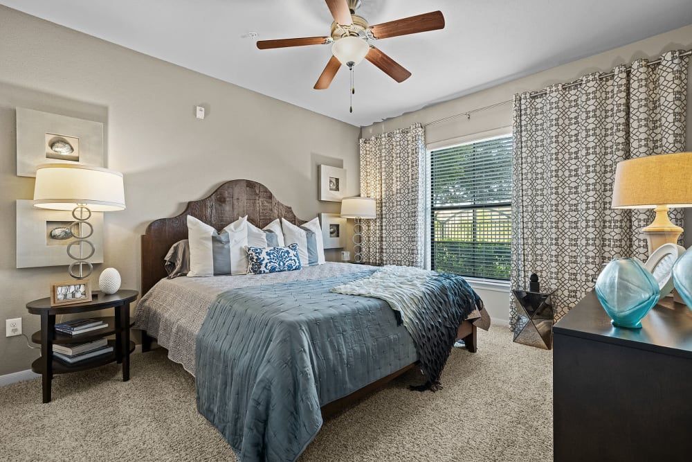 Spacious bedroom with a large bed and a ceiling fan at Marquis at the Reserve in Katy, TX.