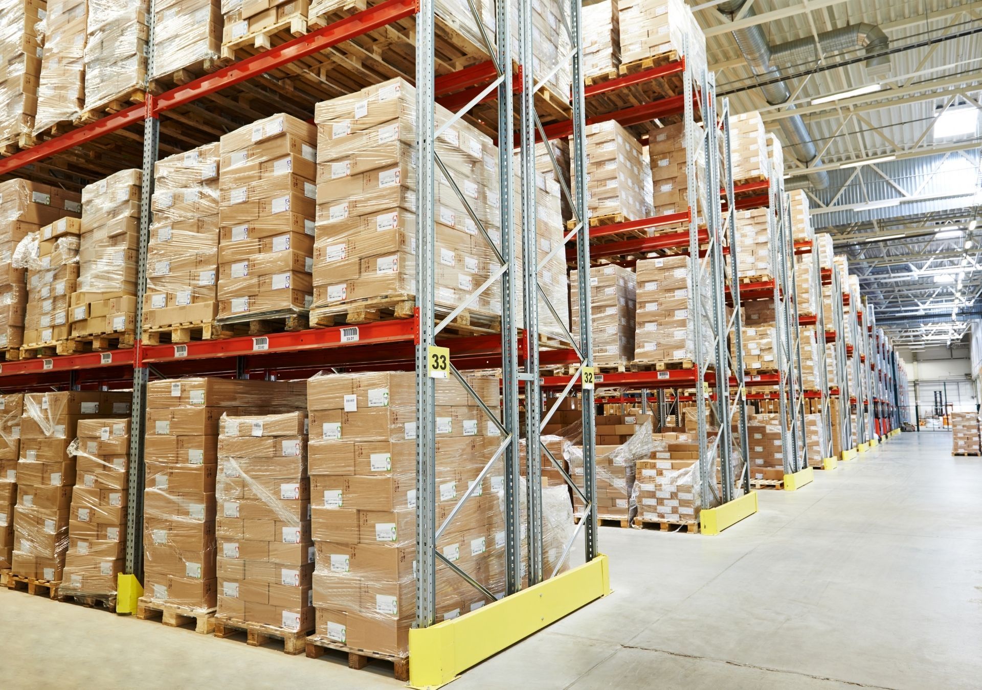 Rows of cardboard boxes stacked on warehouse shelving.