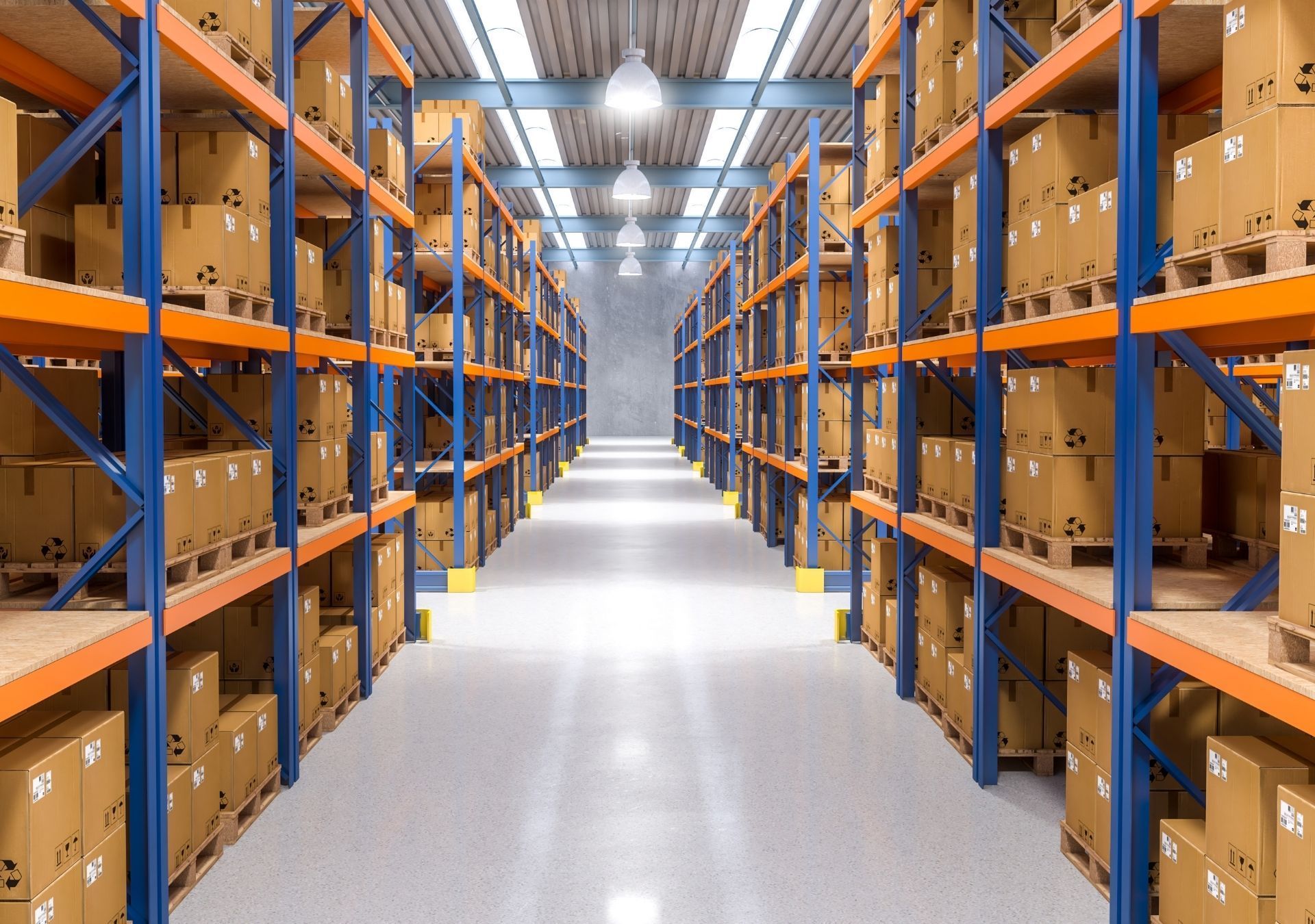 Warehouse interior with tall shelving packed with cardboard boxes. Blue supports, orange shelves, concrete floor.