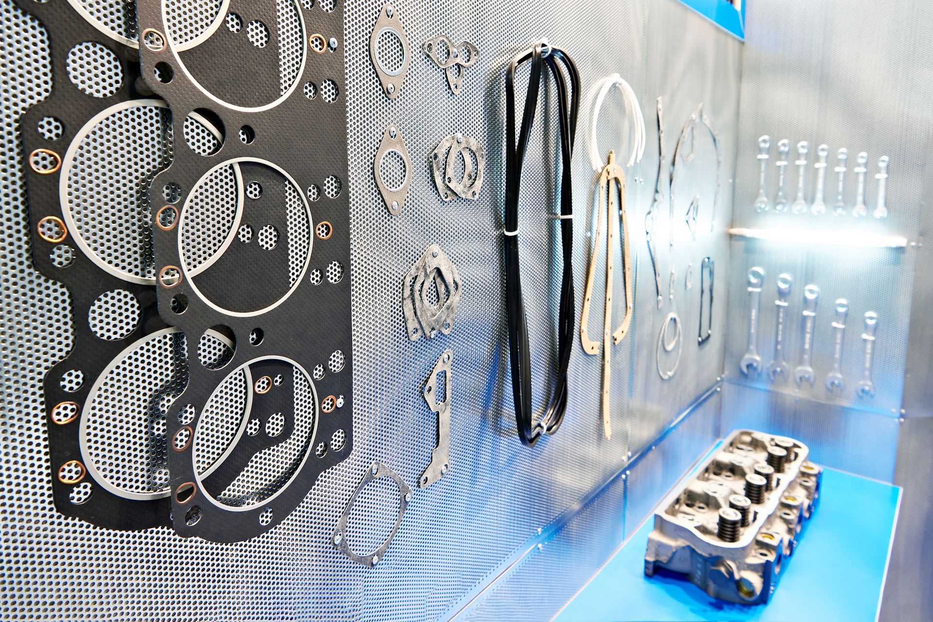 Woman in straw hat smiles, holding wine glass near a lake.