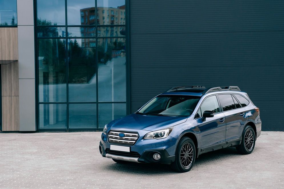 A Blue Subaru Outback is Parked in Front of a Building — Northern Service Centre in Smithfield, QLD