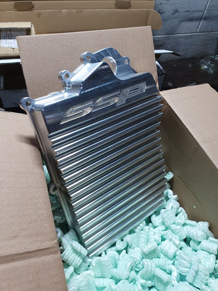 A Metal Object is Sitting in a Cardboard Box Surrounded by Green Foam — Northern Service Centre in Westcourt, QLD