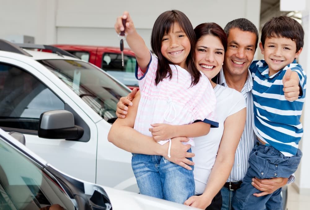 A Family Is Posing for A Picture in Front of A Car — Start Learning Automotive in Melbourne, VIC