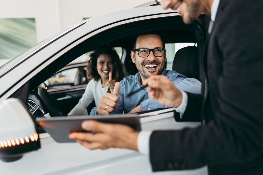 A Man Is Holding a Tablet in Front of A Man in A Car — Start Learning Automotive in Brisbane, QLD