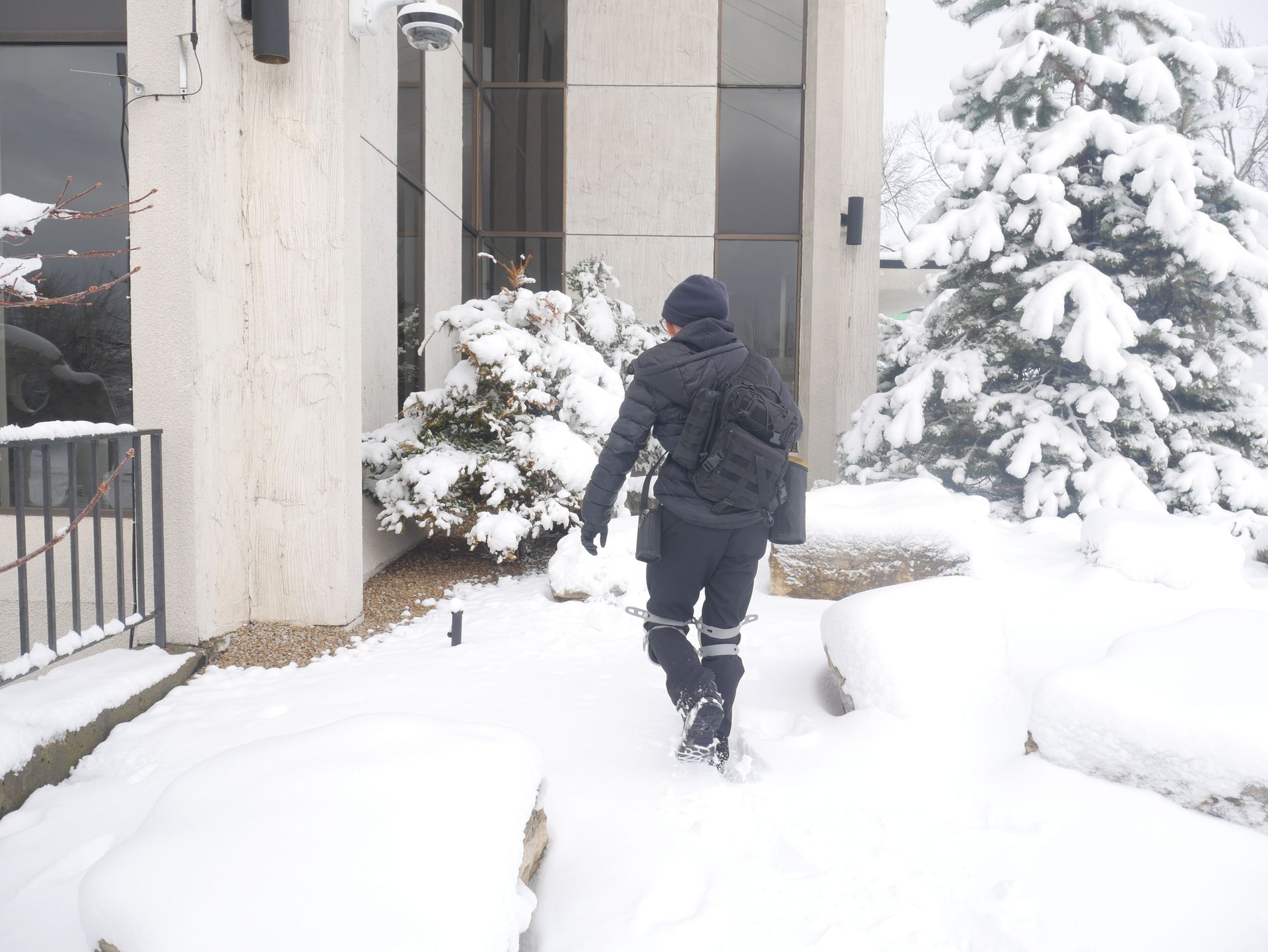 Technician walking through the snow