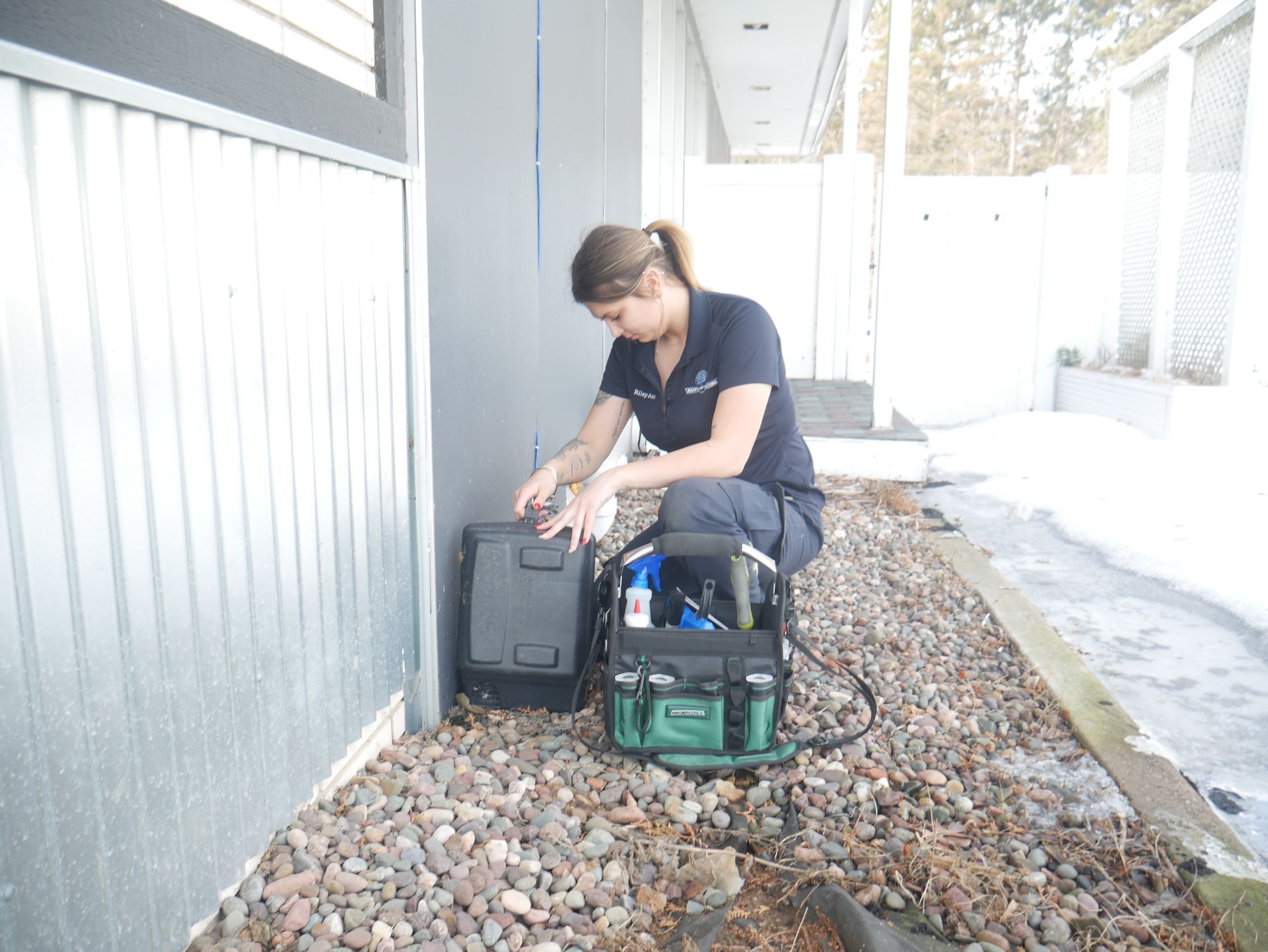Technician checking exterior bait station