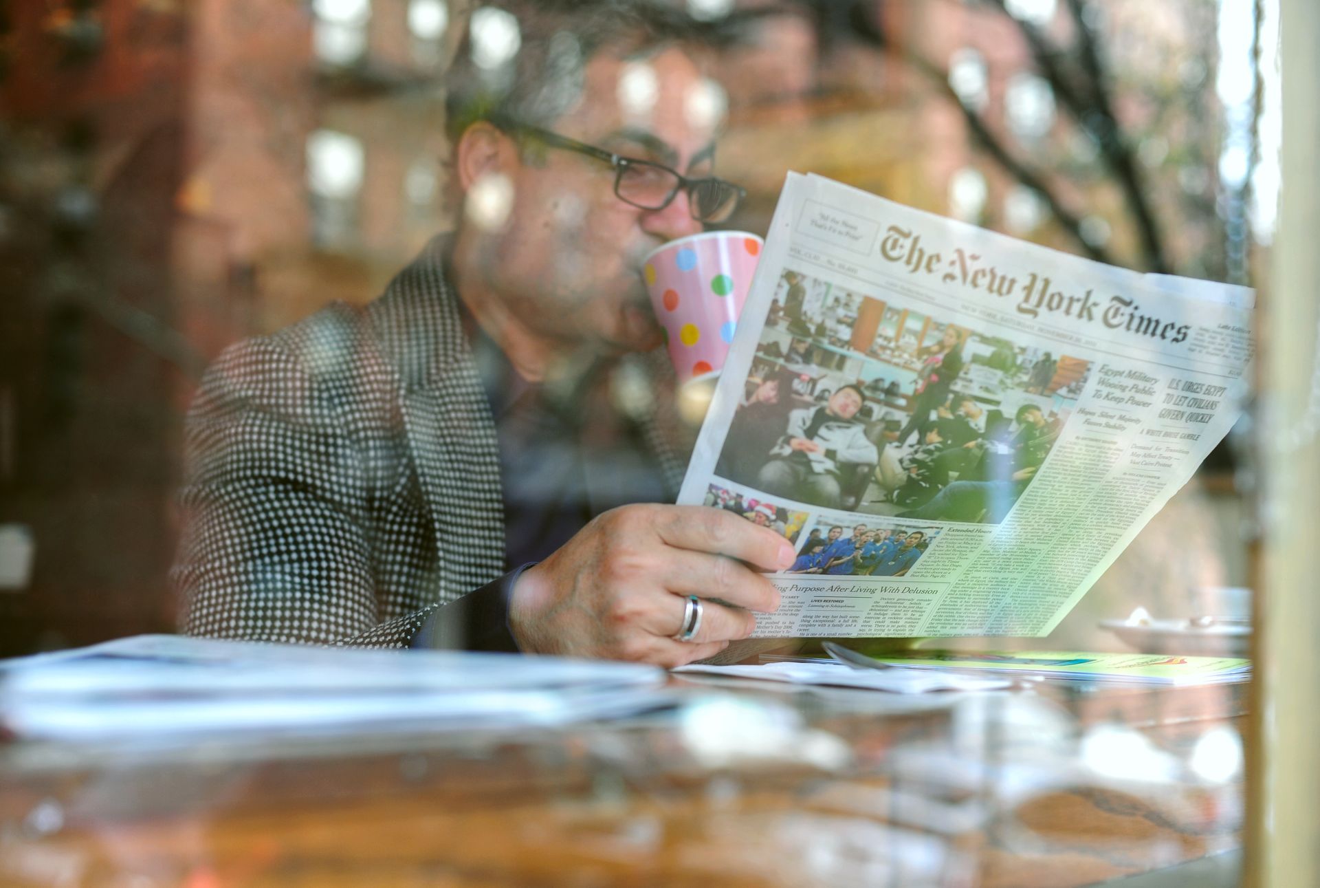 Armen Kojoyian reading the New York Times
