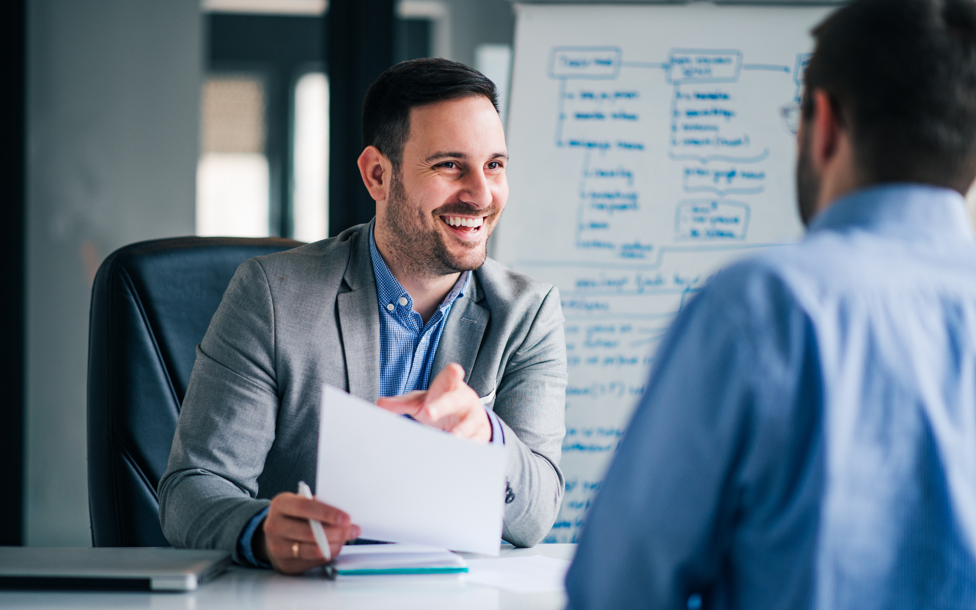 A professional candidate confidently answering interview questions in a corporate office setting.
