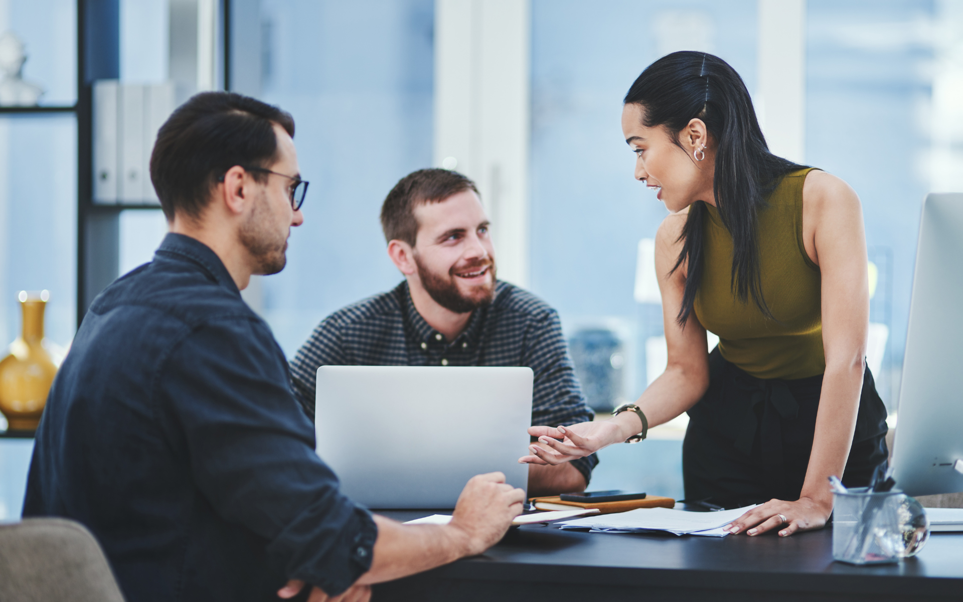 A finance recruiter discussing job opportunities with a candidate in a modern office.