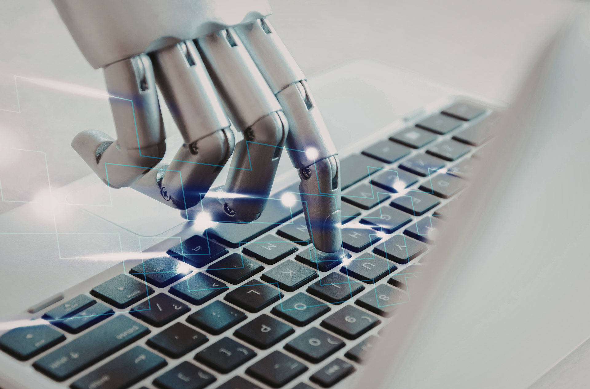 Robotic hand pressing a key on the laptop