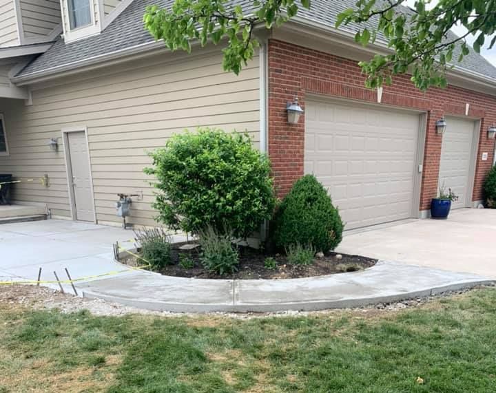 A concrete walkway is being built in front of a house.