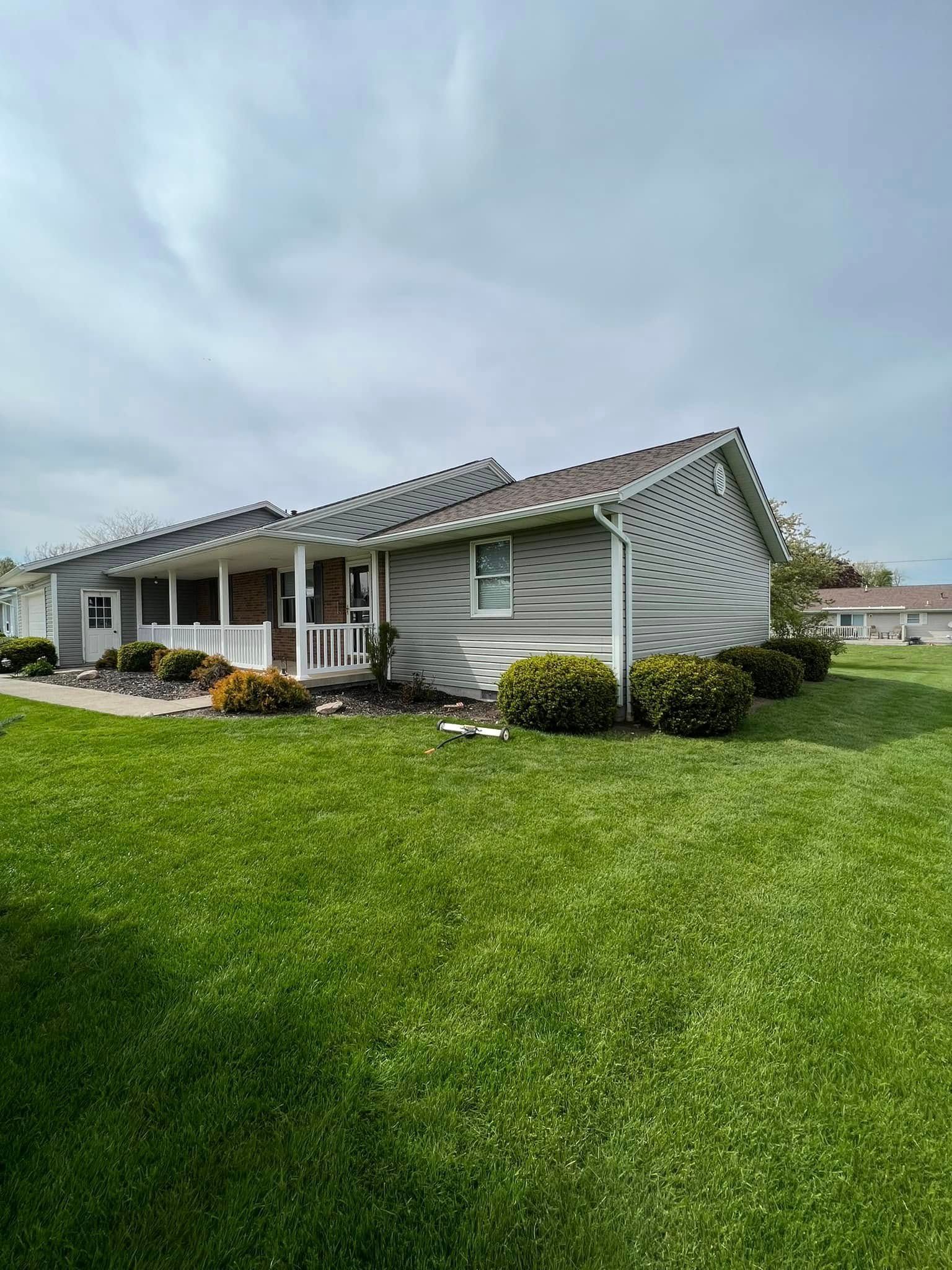 A house with a large lawn in front of it.