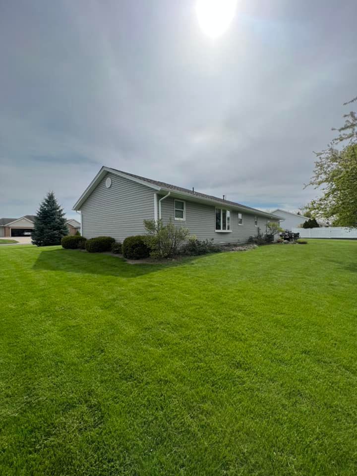 A house with a large lawn in front of it.